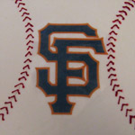 The SF GIANTS logo on a baseball cake.