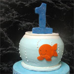 Stacked gold fish bowl and number one for a first birthday cake