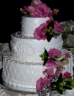 Stacked wedding cake with monogram and fresh flowers