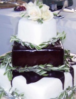 Sugared olive branches and chocolate ganache on square rolled fondant wedding cake