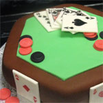 Rolled fondant card table with a roal flush - poker game cake.