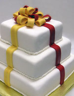 Stacked double layer packages with a fondant bow.