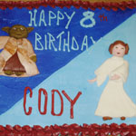 A sheet of cupcakes decorated with Princess Leia and Yoda (Star Wars)